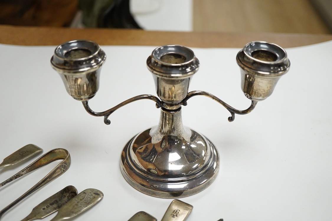 A small group of silver including a modern two branch, three light dwarf candelabrum by Sanders & Mackenzie, height 10.2cm, weighted, a pair of handled glove stretchers and eight small items of flatware.